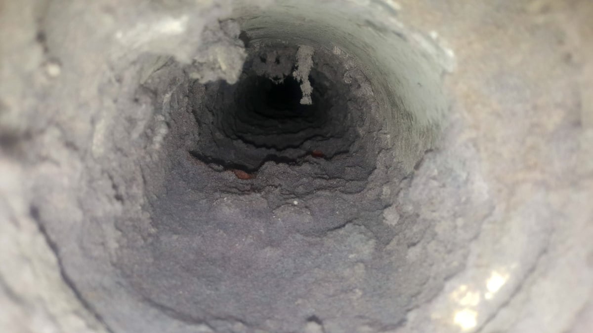 A dryer vent clogged with lint and debris
