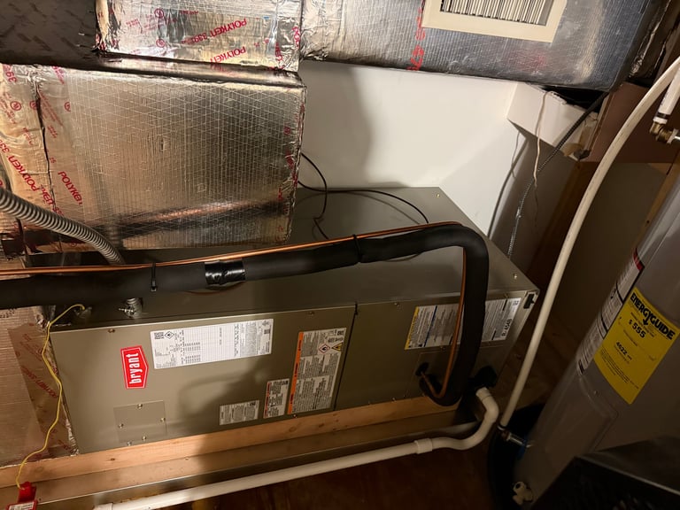 HVAC furnace unit with piping and ductwork in a utility room or basement space
