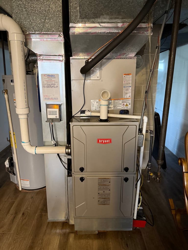 Bryant furnace unit with water heater and ductwork in basement utility room