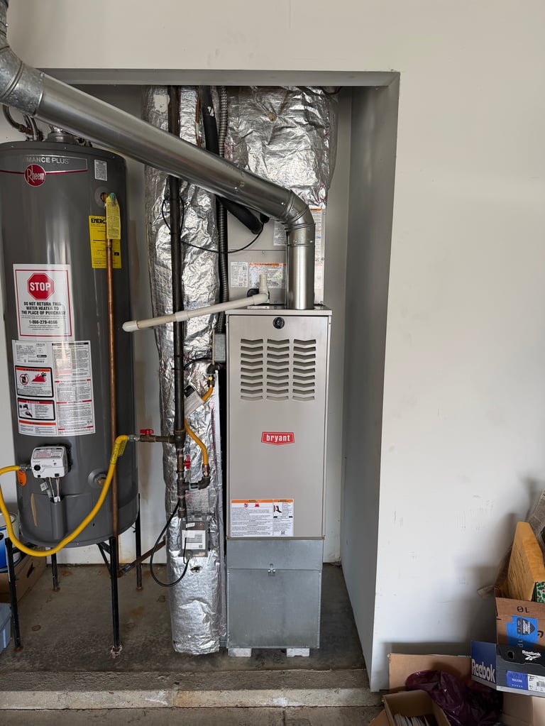 HVAC system with furnace unit, ductwork, and water heater installed in utility closet