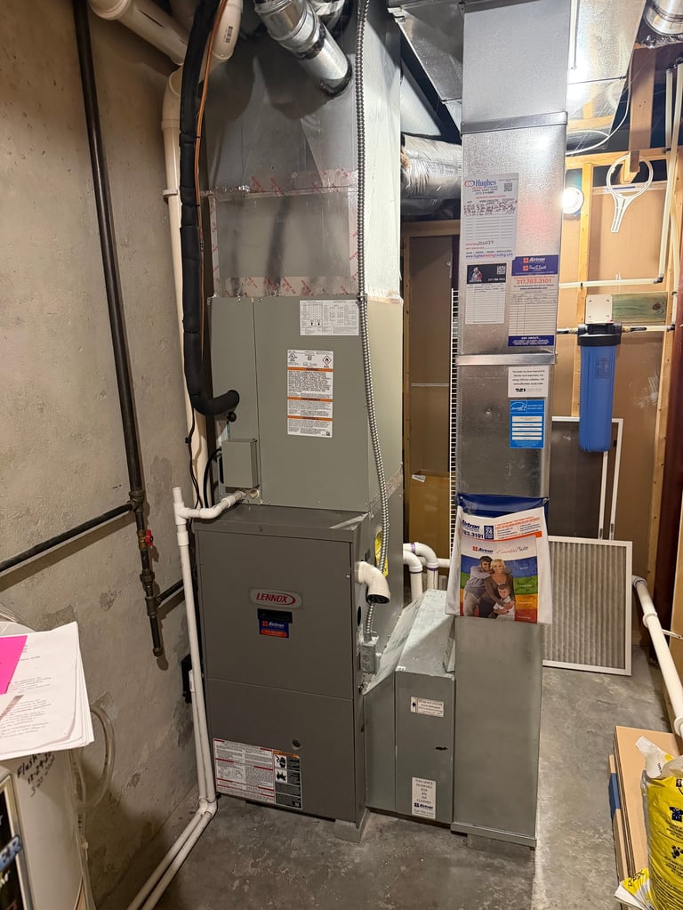 HVAC furnace and air handling system installed in a residential basement with ductwork and equipment visible